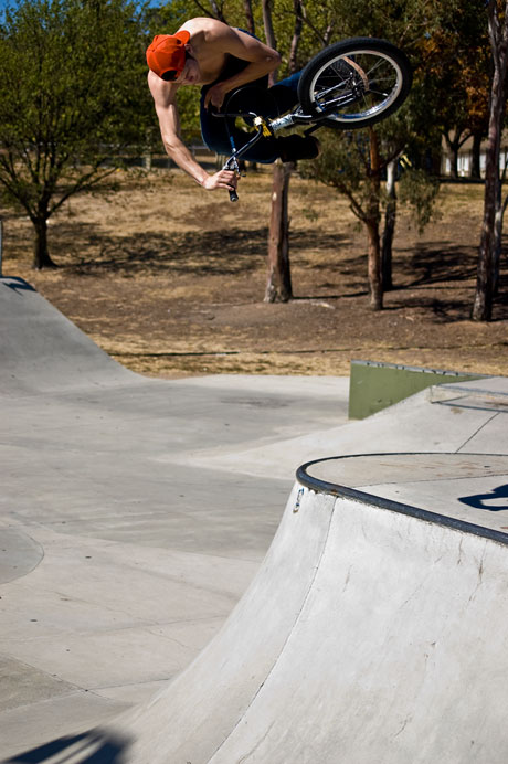 Geoff floats an opposite switch footed table over one of the hips at Western Creek Skatepark