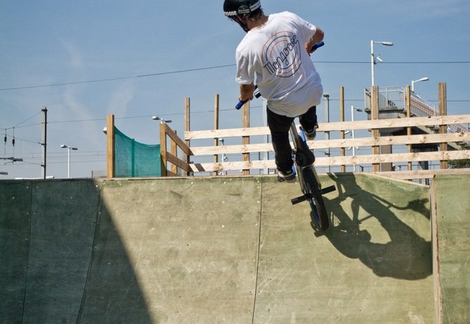 How high you air is up to you. You just need enough time to get the bars around. Height will give you more time to spin, but just do an amount that’s comfortable for your ability.