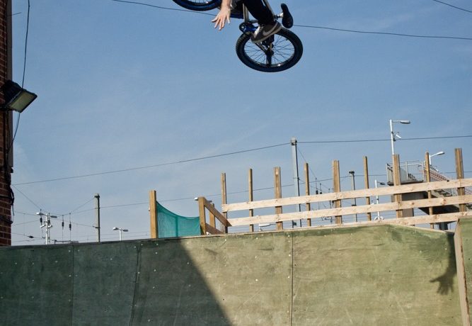 When you come to the top of the air, throw your arms off. If you’re leaning over the front enough, with the bars locked in position, the bike shouldn’t move anywhere.