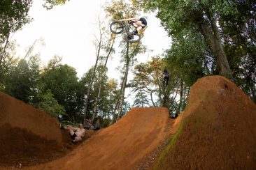 Martin Woodwardle with a one foot tyre grab over a large gnarly jump. Martin builds unreal trails his dedication and hours digging he puts in is mind blowing. 